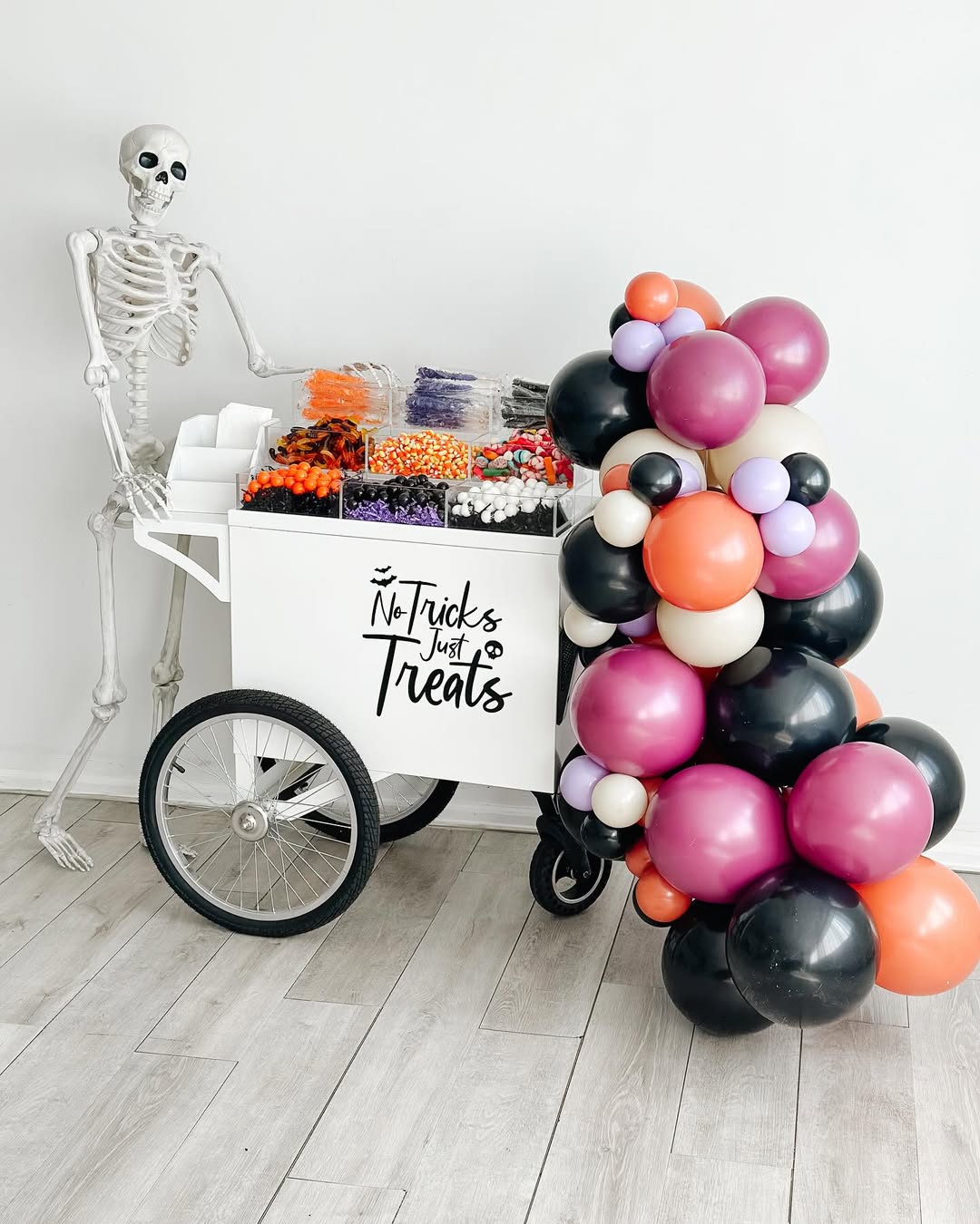 The Classic Cart — vintage candy cart with Halloween theme and balloon garland